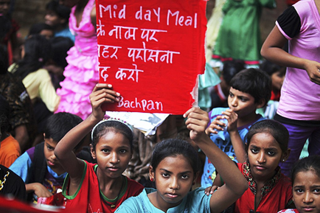 Indian children protest against the deaths of schoolchildren after eating free midday meals served at a school, in New Delhi, India, on Saturday. Photo: AP