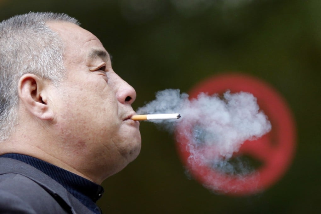 A man smokes next to a "No Smoking" sign in Shanghai. China is the largest consumer of tobacco. Photo: Reuters