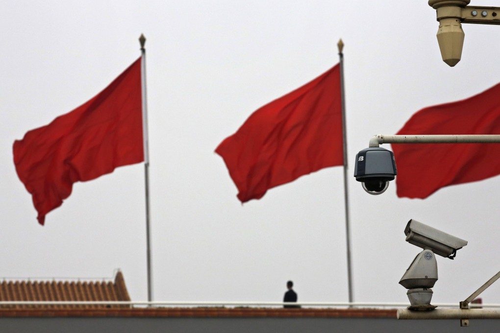 A security camera stands next to flags at Tiananmen Square in Beijing. Photo: Reuters