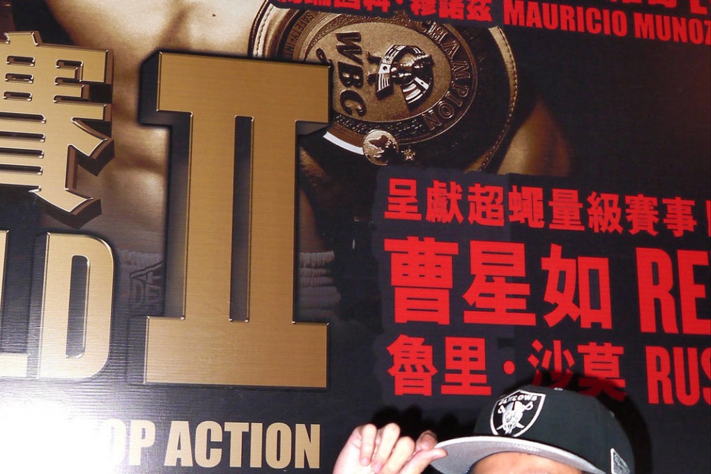 Hong Kong boxer Rex Tso poses in front of his own poster at the Fists of Gold II press conference at the Venetian, Macao. Photo: Unus Alladin
