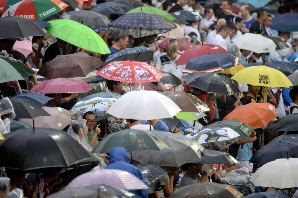 Umbrellas are the order of the day at the stadium. Photo: AFP