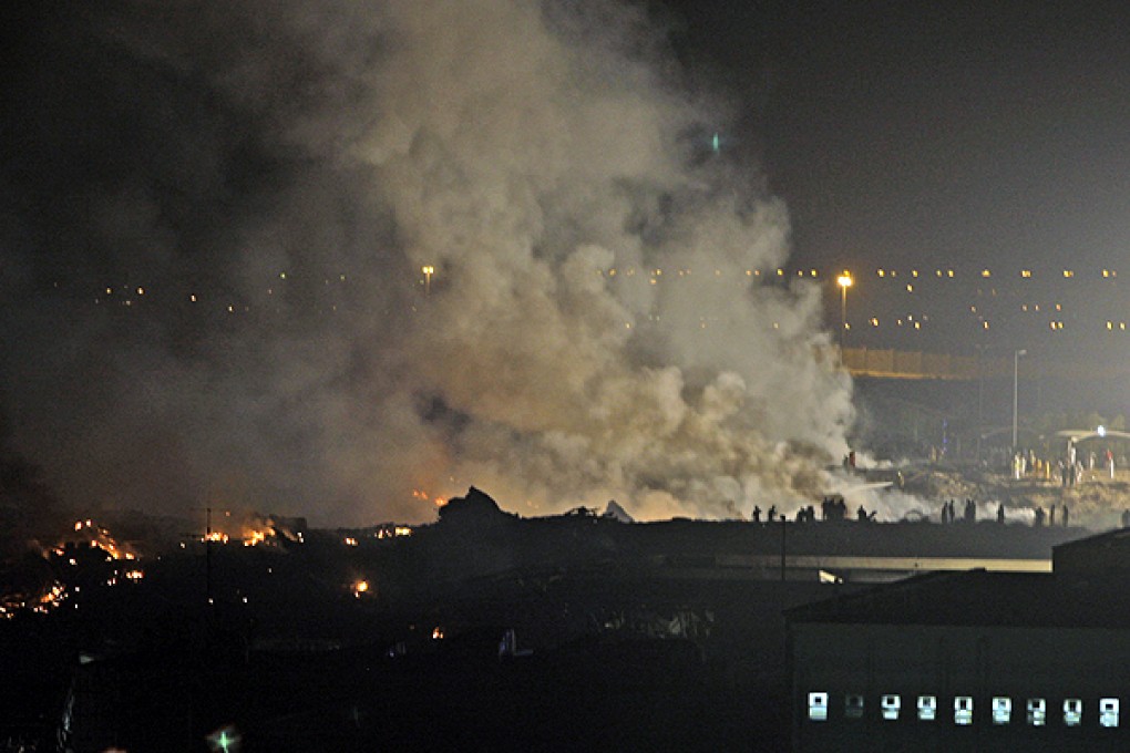 Smoke rises from the site of a cargo plane crash in Dubai, United Arab Emirates. Photo: AP
