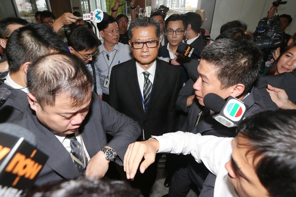 Paul Chan meets the media after a special meeting of Legco's development panel. When asked by one lawmaker if he would resign, Chan replied: "Definitely not." Photo: Sam Tsang