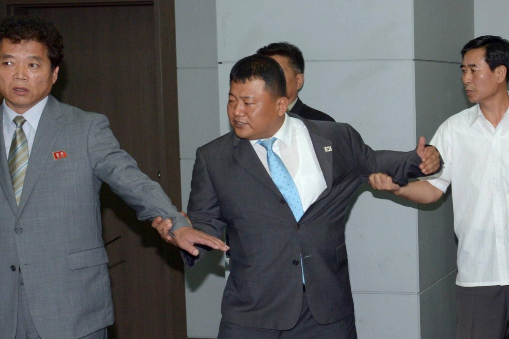 A South Korean official (centre) tangles with representatives of the North during the scuffle at the Kaesong industrial estate.Photo: AFP