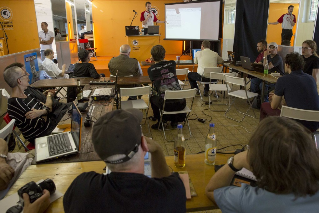 People watch a briefing on how to protect online privacy organised by Germany’s Pirate Party. Growing concerns about online snooping have led to voluntary privacy guidelines for mobile apps. Photo: Reuters