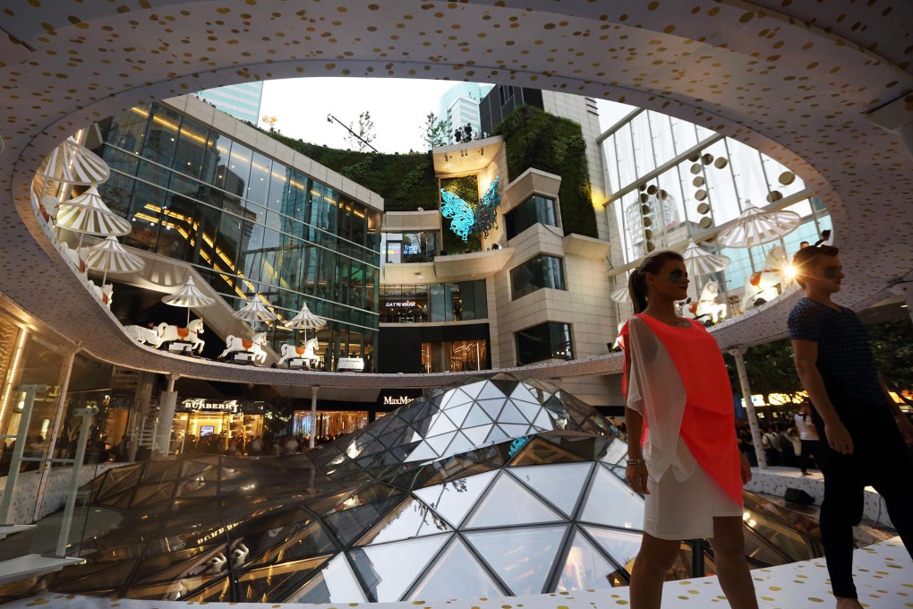 Dancers perform in the atrium of New World Development's K11 Art Mall in Shanghai at its opening ceremony in June. Photo: Bloomberg