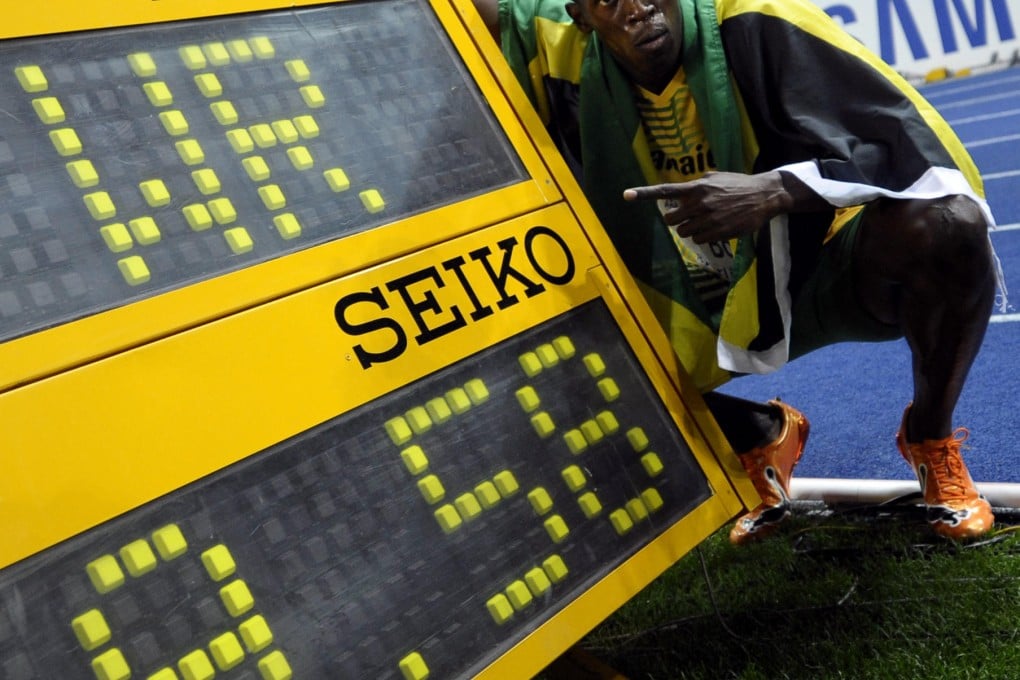 Usain Bolt next to the race clock in Berlin in 2009. Photo: AFP