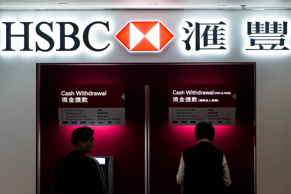 Two men use ATM machines at an HSBC branch in Hong Kong. Photo: ATM