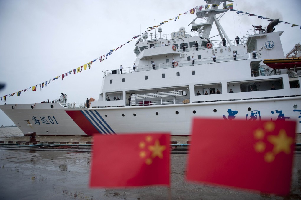 Crew members stand on the deck of the "Haixun 01" of China's Maritime Safety Administration (MSA) at Bo Aung Kyaw Jetty in Yangon. Photo: AFP