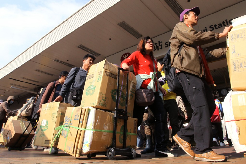Parallel traders prepare to transport their goods at Sheung Shui train station. Photo: Edward Wong