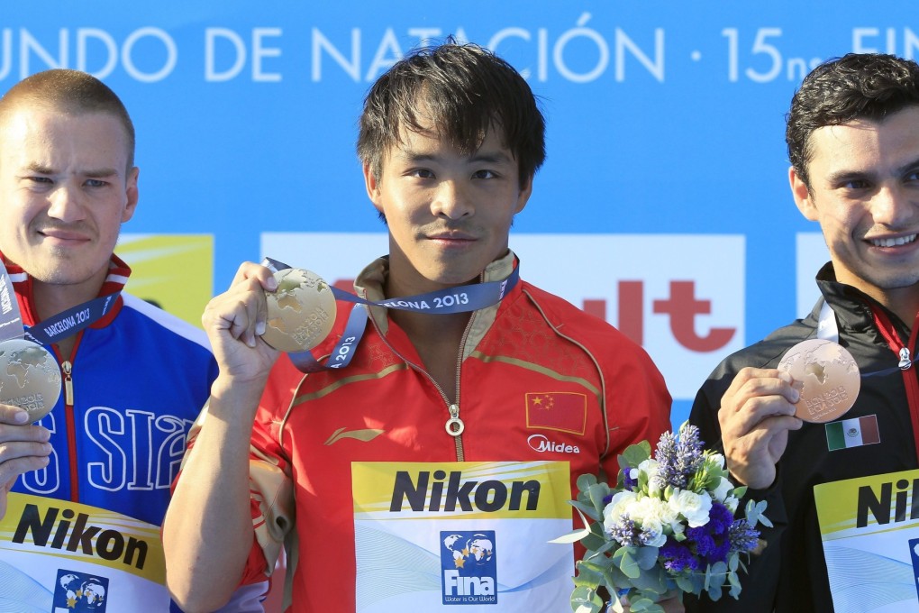 Silver medalist Russian diver Evgeny Kuznetsov (left), gold medalist Chinese Chong He (centre) and bronze winner Mexican Yahel Castillo (right) on the podium after the men's 3-metre springboard diving final of the 15th FINA Swimming World on on Friday. Photo: EPA
