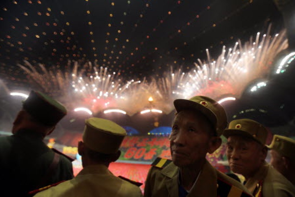 North Korean war veterans watch fireworks during the "Arirang" mass games song-and-dance ensemble, on the eve of the 60th anniversary of the Korean War armistice. Photo: AP