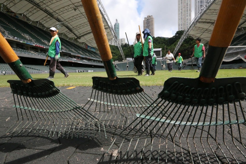 Ground staff work on the pitch at the Hong Kong Stadium ahead of tonight's clash between Manchester United and Kitchee. Photo: Felix Wong