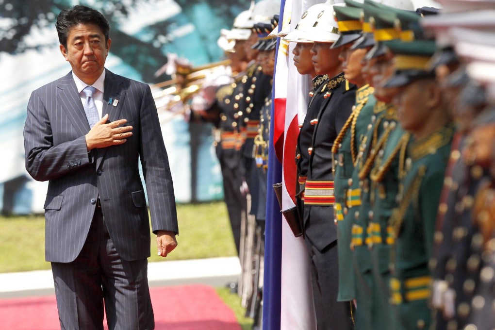Japanese Prime Minister Shinzo Abe reviews honour guards during his official visit at the Malacanang presidential palace in Manila yesterday. Photo: EPA
