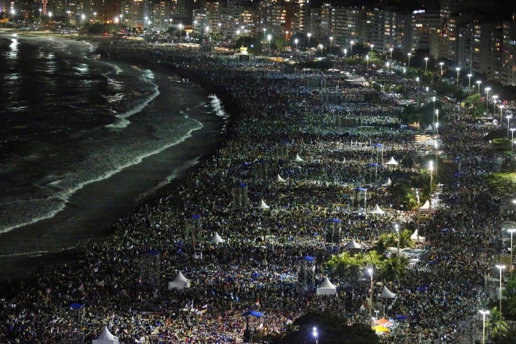 Catholic faithful crowd the streets and beach as Pope Francis gives Mass during World Youth Day in Rio de Janeiro on Saturday. Photo: Reuters