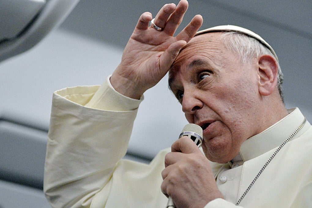 Pope Francis talks with journalists as he flies back Rome following his visit to Brazil. Photo: Reuters