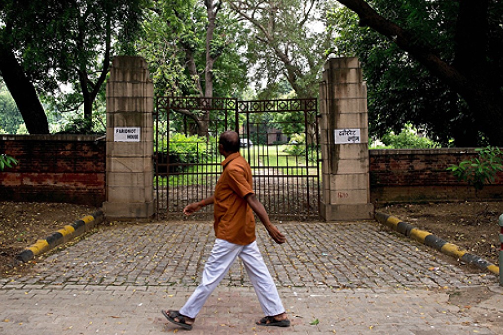 An Indian man walks past the premises of the Faridkot House complex in New Delhi on Monday. Photo AFP