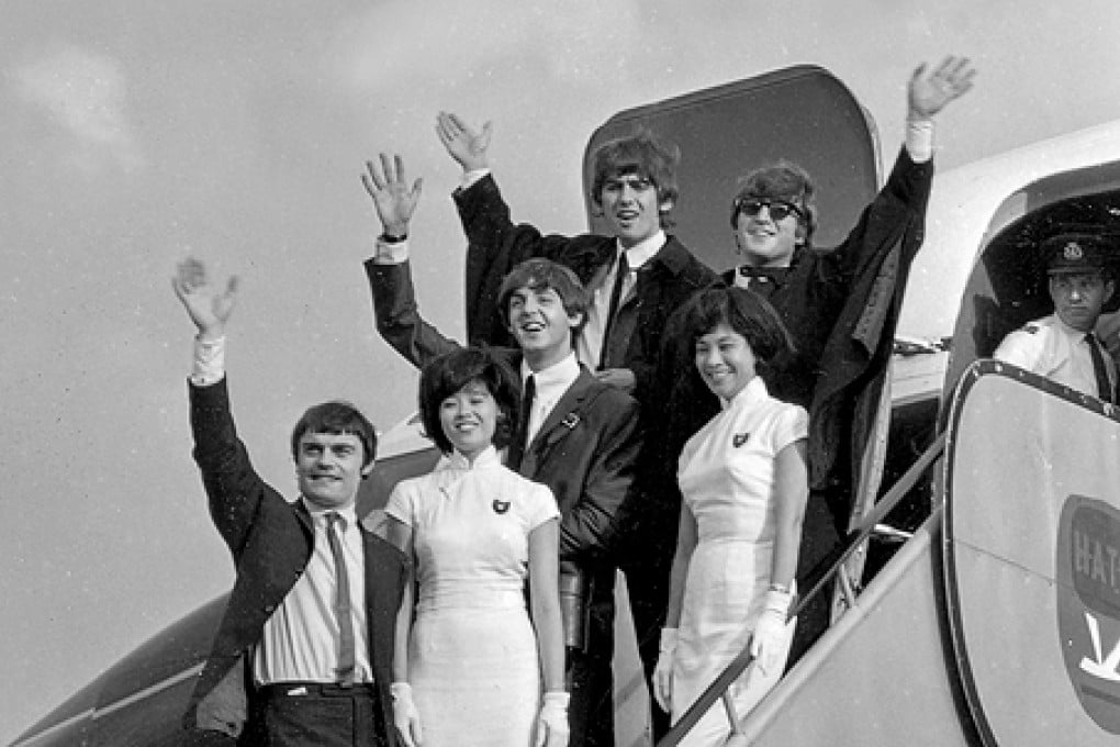 The Beatles, with replacement drummer Jimmy Nicol (front), wave to fans on arriving at Kai Tak on June 8, 1964.