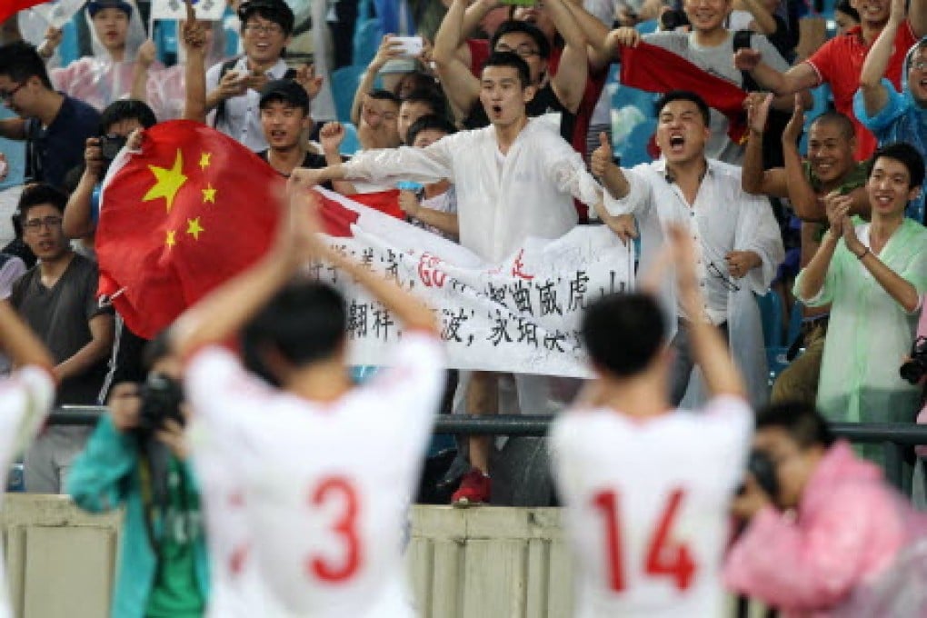 Chinese fans applaud their team, which finished as runners-up in the East Asian Cup. Photo: Xinhua