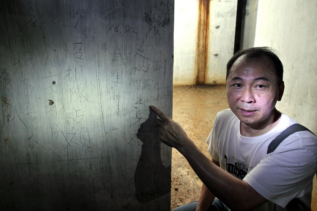 Military history expert Ko Tim-keung points to the Japanese inscriptions in the Shing Mun Redoubt tunnel. Photo: Dickson Lee