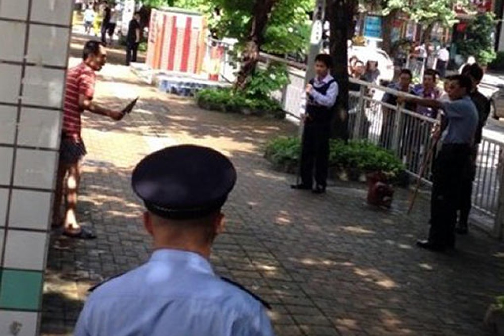 A mobile phone photo shows police confronting the knifeman after his deadly rampage in Shenzhen's Luohu district. Photo: Xinhua
