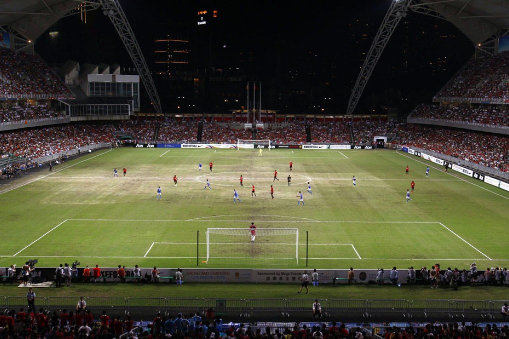 Manchester United and Kitchee play on partly sandy ground during their friendly match at the Hong Kong Stadium. Photo: Reuters