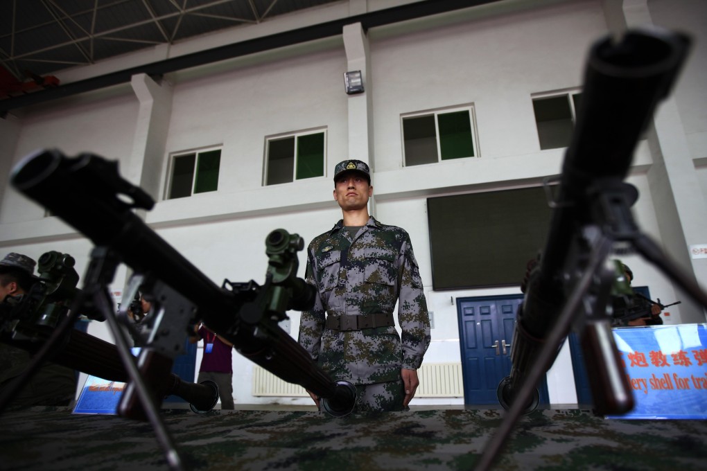 A soldier from the PLA's Air Defence Brigade, 47th Combined Corps, stands beside Type-69 40mm rocket propelled grenades during a rare display organised for the media by the Chinese government in Lintong, Shaanxi province, on Monday. Photo: Reuters