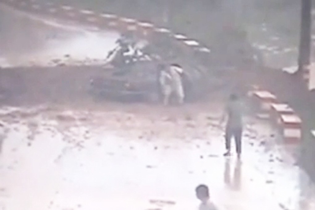 Three passengers emerge from the vehicle before helping a four person escape. Photo: SCMP Pictures