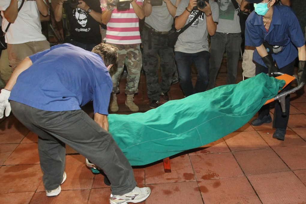 The bodies of a woman and two young children who have been found dead in a flat in Shau Kei Wan are being remove from the flat. Photo: Edward Wong