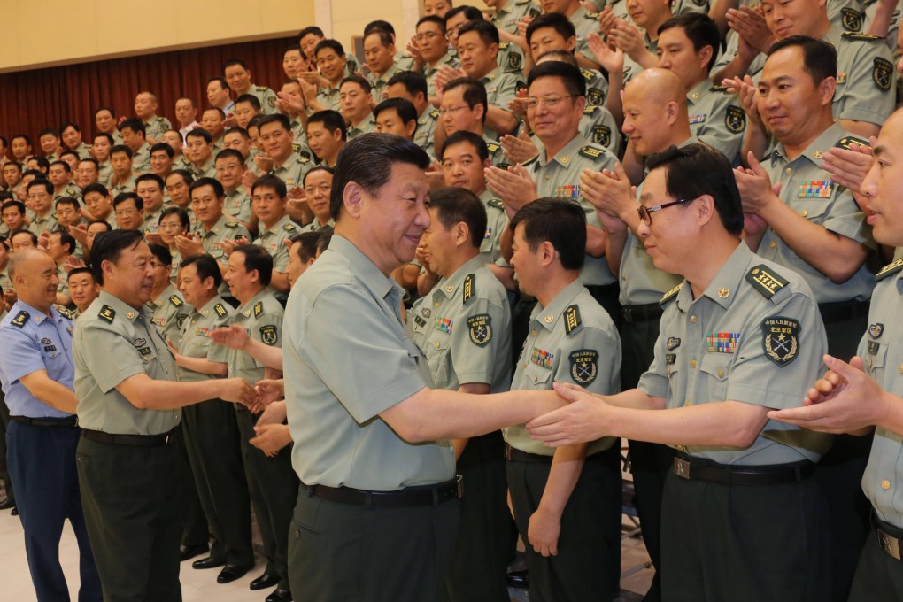Xi Jinping shakes hands with a military cadre during a tour of the Beijing military area command in the capital ahead of Army Day today, the 86th anniversary of the founding of the PLA. Photo: Xinhua
