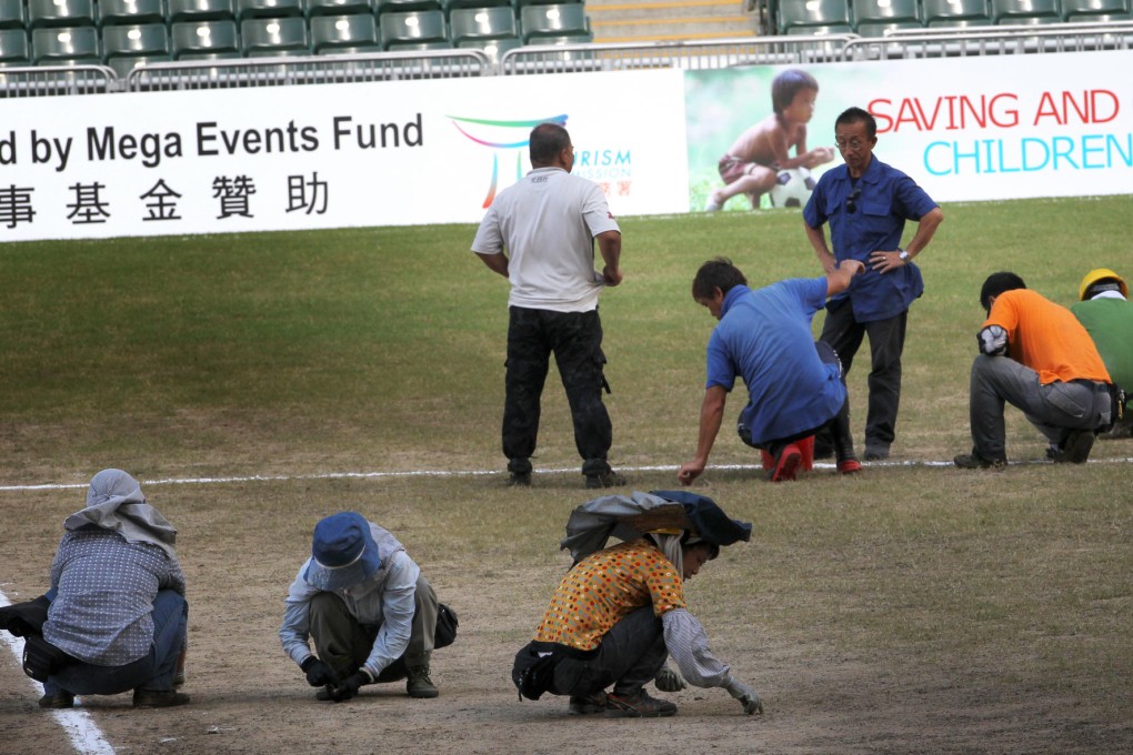 Workers maintain the Hong Kong Stadium turf. Photo: May Tse