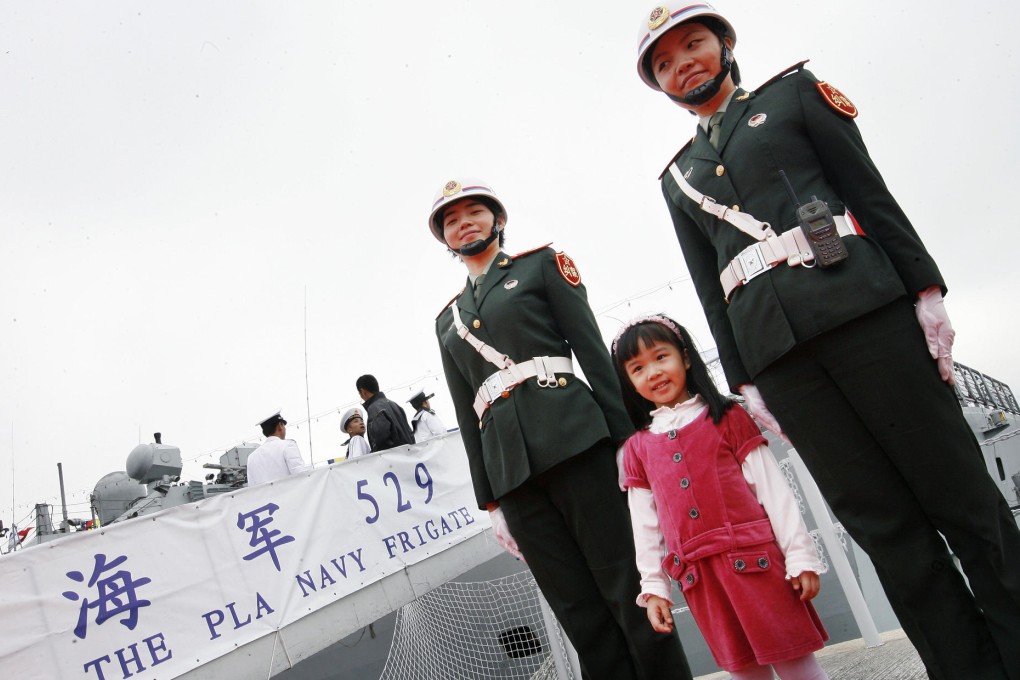 A Hong Kong girl gets an up-close look at missile frigates at the PLA barracks at Stonecutters Island in this file photo. Photo: May Tse