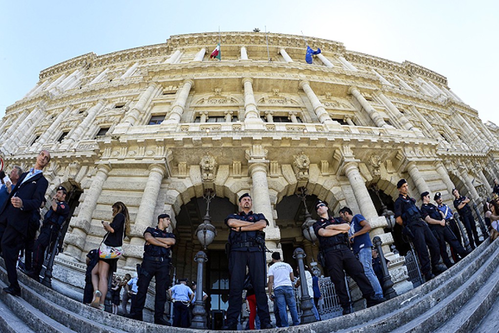 Carabinieri stand in front of the Court of Cassation building in Rome. Photo: AFP