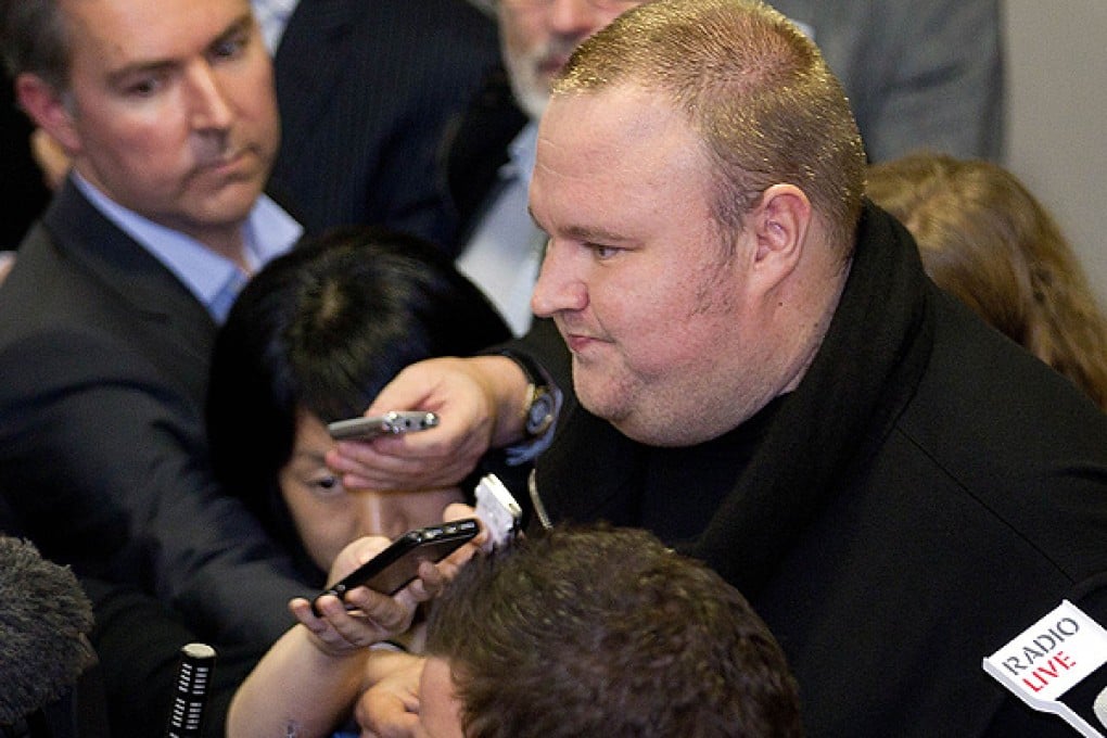 Megaupload founder Kim Dotcom speaks to the media after coming face to face for the first time with New Zealand Prime Minister John Key. Photo: AFP