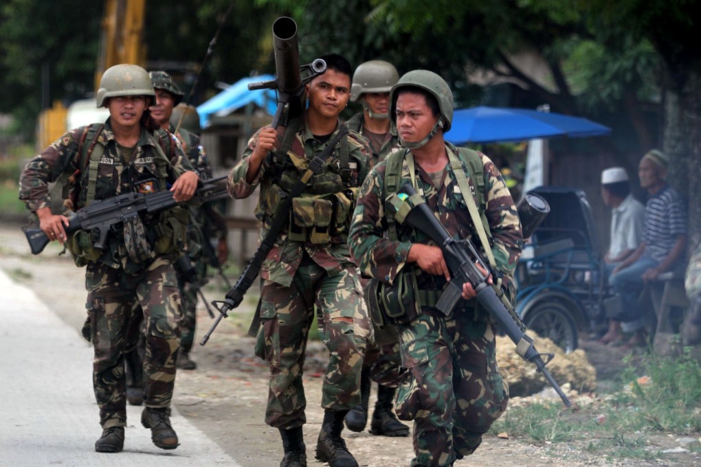 Philippine troops patrol a highway in Guindulugna town, Maguindanao province, on southern island of Mindanao on Wednesday. Photo: AFP