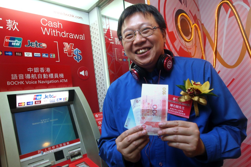 Alex Chan Chi-kwong demonstrates how to use the new voice navigation ATM machine. Photo: May Tse