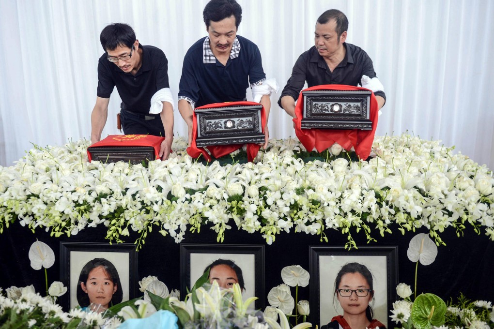 The fathers of pupils (from left) Liu Yipeng, Wang Linjia and Ye Mengyuan - victims of the Asiana plane crash in San Francisco - carry their daughters' urns at a service in Jiangshan yesterday. Photo: Xinhua