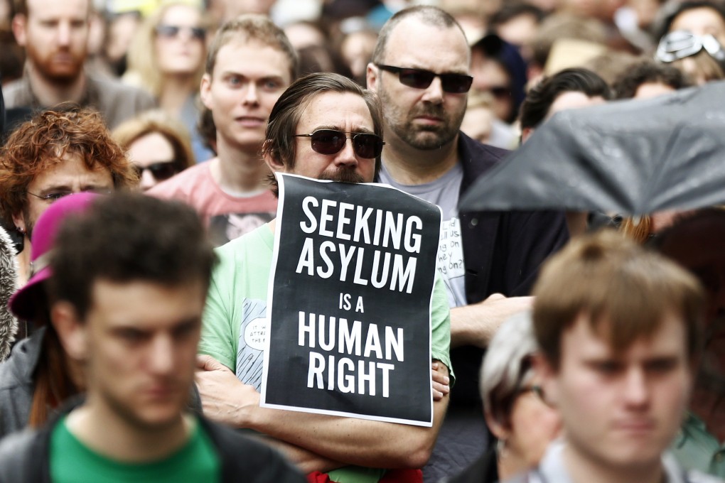 A protester in Sydney holds a poster during a rally in support of asylum seekers on July 20. Photo: Reuters