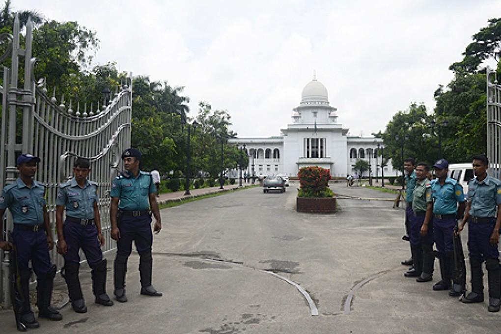 Bangladeshi police stand guard in front of the high court in Dhaka on Thursday. Photo: AFP