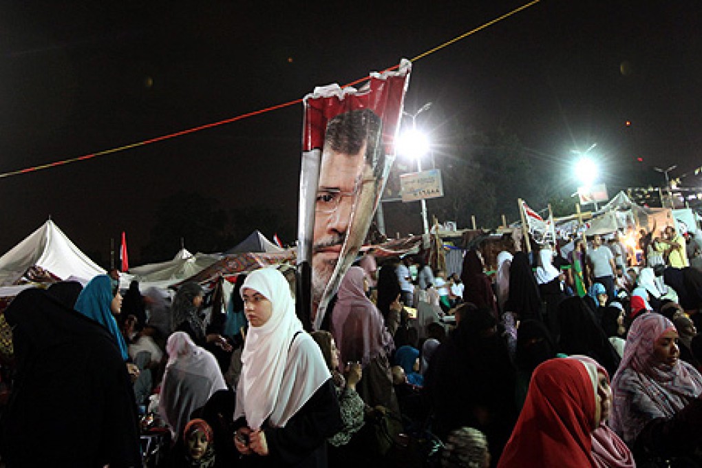 Women supporting ousted president Mohammed Mursi attend a protest near Rabaa al-Adawiya mosque. Photo: EPA