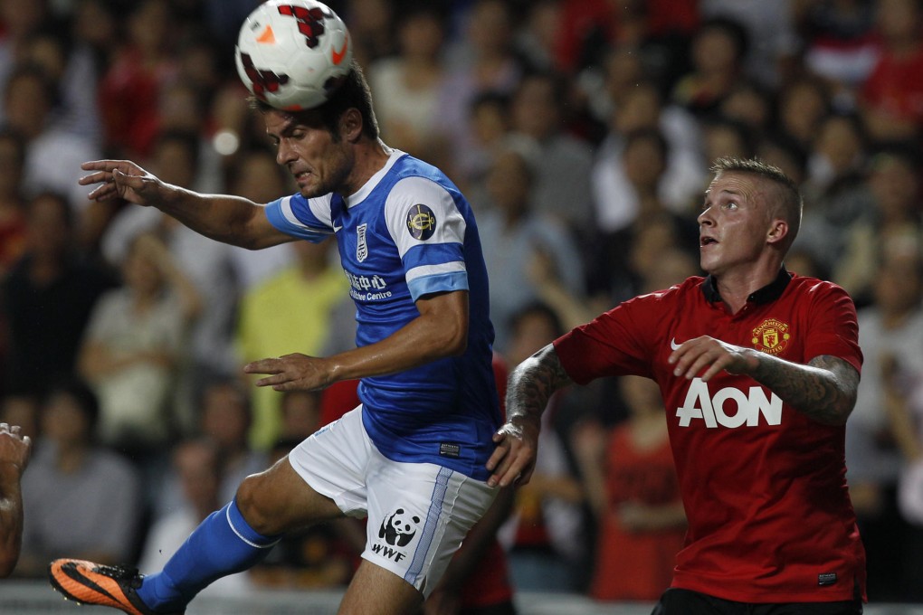 Kitchee's Jorge Tarres and United's Alexander Buttner. Photo: AP