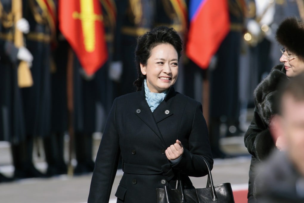 Peng Liyuan smiles after arriving at the government airport Vnukovo II, outside Moscow in March. Photo: AP