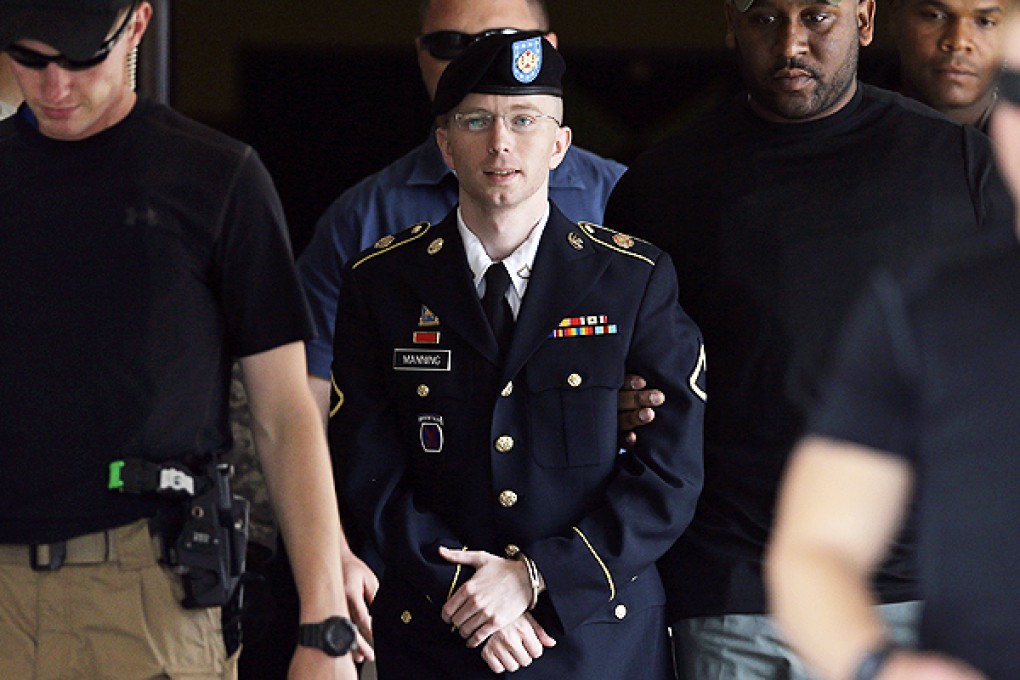 A handcuffed Bradley Manning leaves court at Fort Meade, Maryland, with a guiding hand from a guard. Photo: AFP