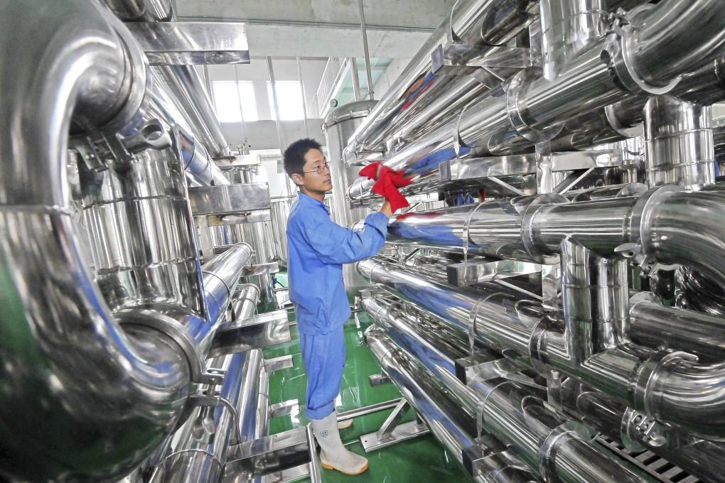 An employee wipes equipment on the production line of a factory in Weifang, China. Photo: Reuters