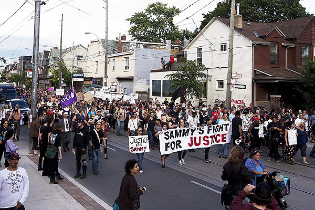 Protesters march on Toronto's Dundas Street, the scene of the shooting of teenager Sammy Yatim. Photo: AP