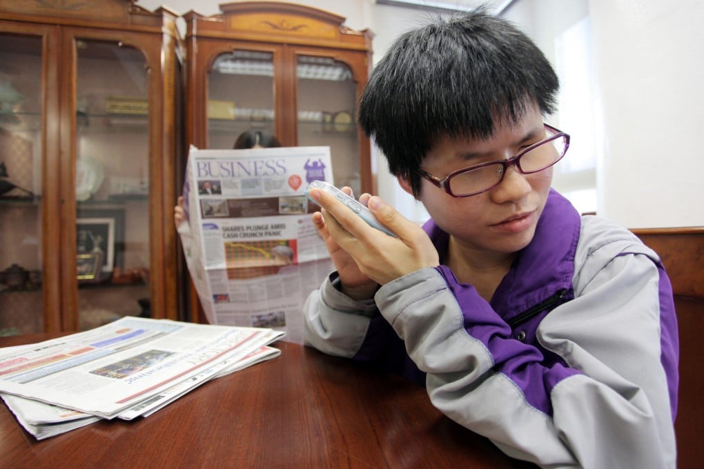 Becky Mok scrolls through her voice-enabled smartphone and listens as the app "reads" material out to her.