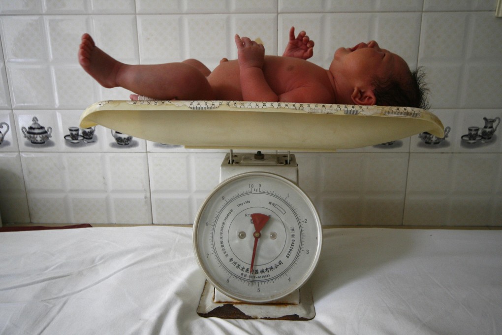 A baby cries on a weighing scale at a local hospital in Suining, in southwest China's Sichuan province. Photo: AP