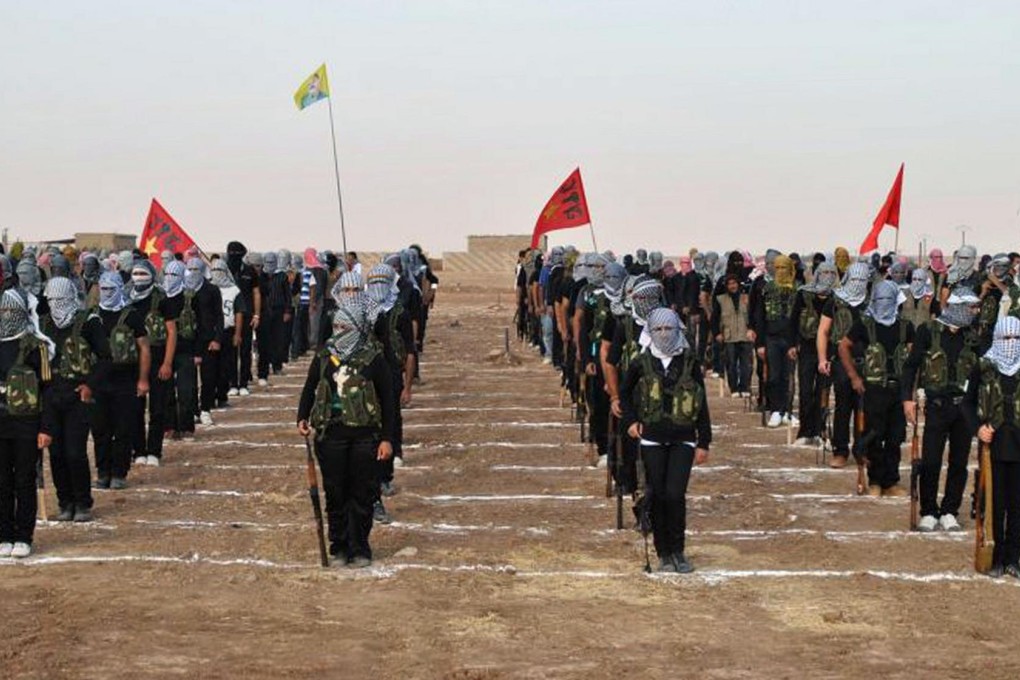 Kurdish opposition fighters take part in a ceremony in the north- eastern Syrian border village of Qamishli.Photo: AFP