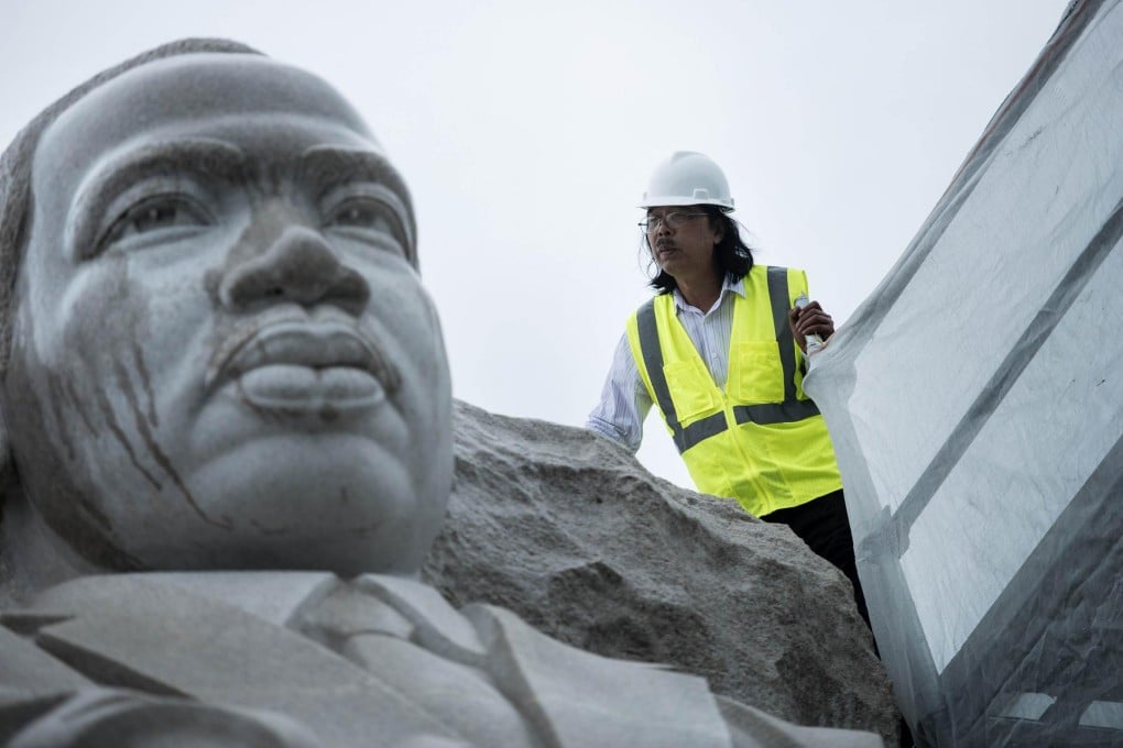 Sculptor Lei Yixin assesses the task ahead. Photo: AFP