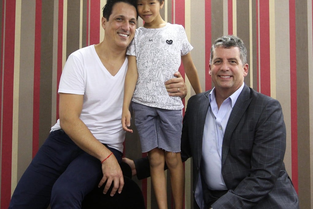 Proud parents Santo Rizzuto (left) and Walter Jennings with their son, Ethan. Rizzuto can only get a six-month visa. Photo: Jonathan Wong